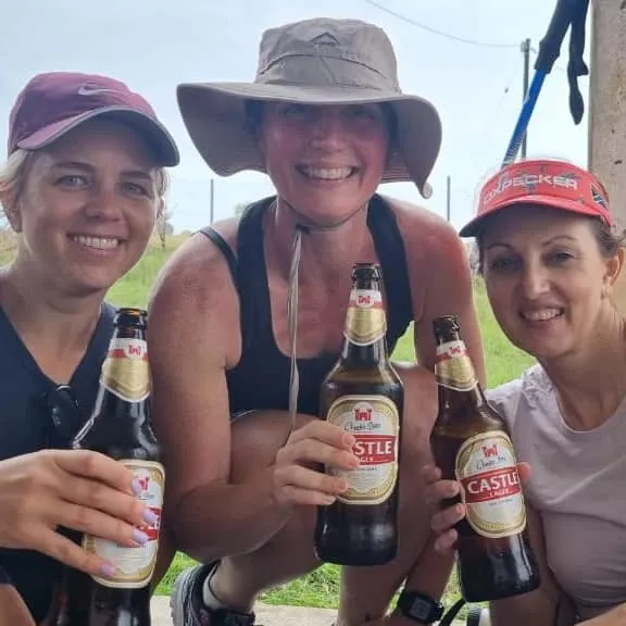 Hikers celebrating with drinks after completing the Wild Coast trail