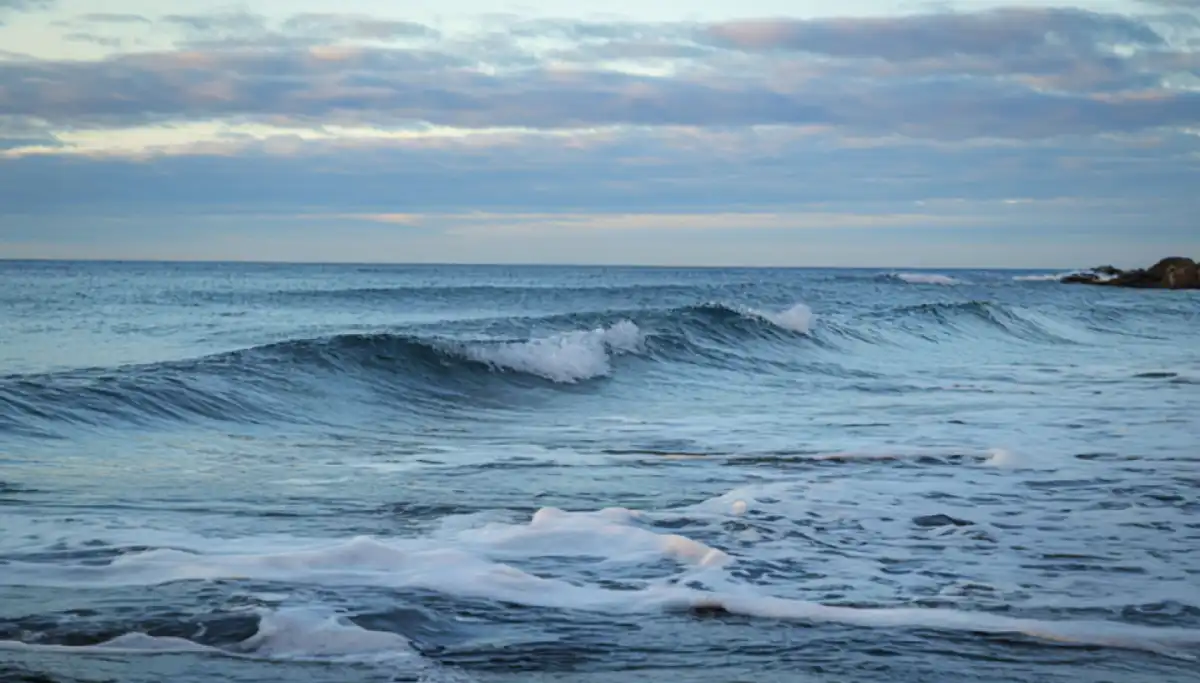 Rolling Indian Ocean waves breaking on the Eastern Cape Wild Coast shoreline at dusk